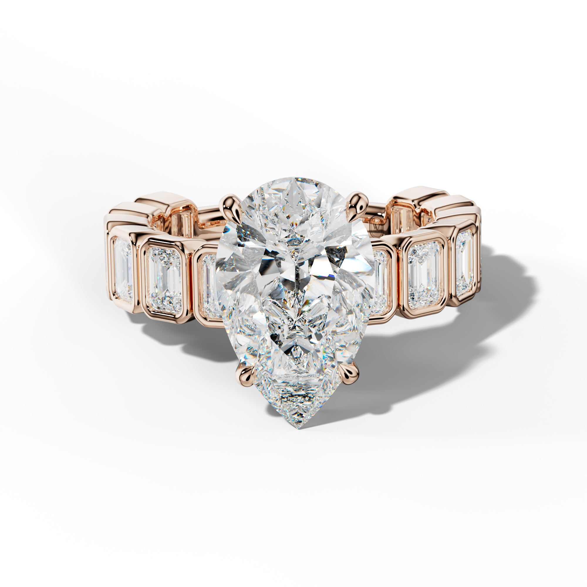 Maizie Pear Shape Engagement Ring With Emerald Side Stones