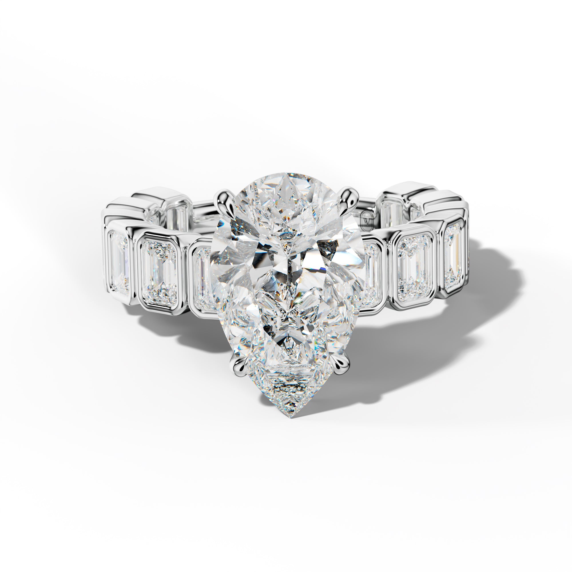 Maizie Pear Shape Engagement Ring With Emerald Side Stones