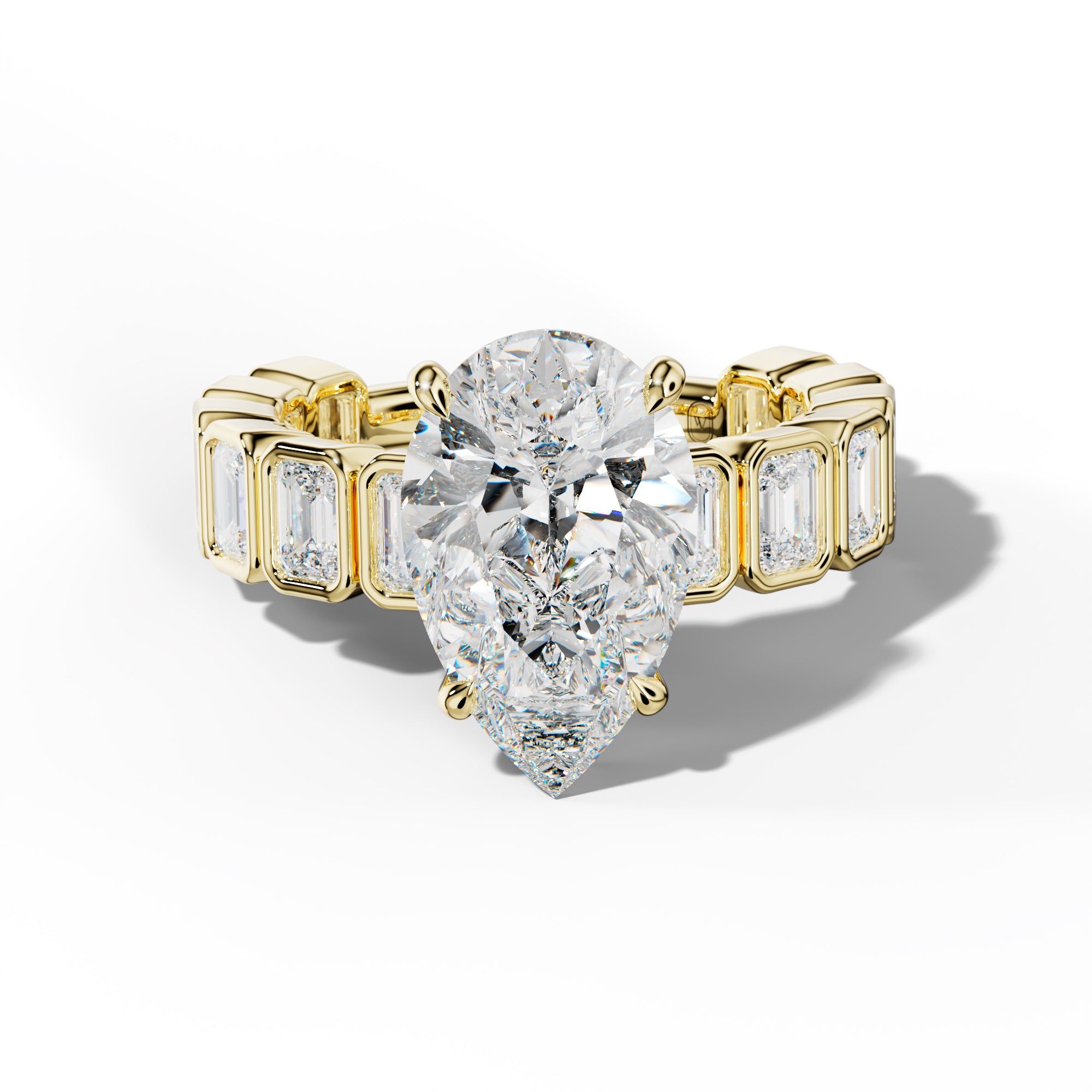 Maizie Pear Shape Engagement Ring With Emerald Side Stones